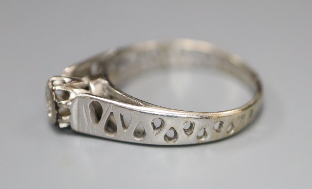 A diamond and 18ct white gold solitaire ring with pierced shank, size L/M, gross 2.9 grams.
